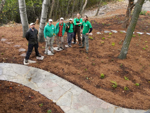 Good Oak staff standing next to a completed hardscaping project